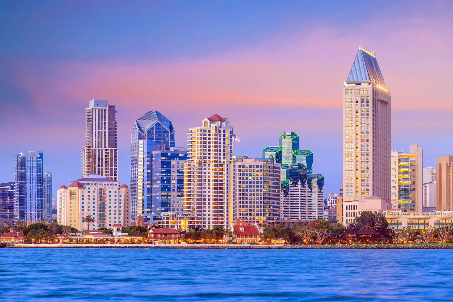 San Diego downtown skyline highlighting the dynamic real estate market, featuring houses for sale in San Diego County with modern high-rises and scenic coastal views.