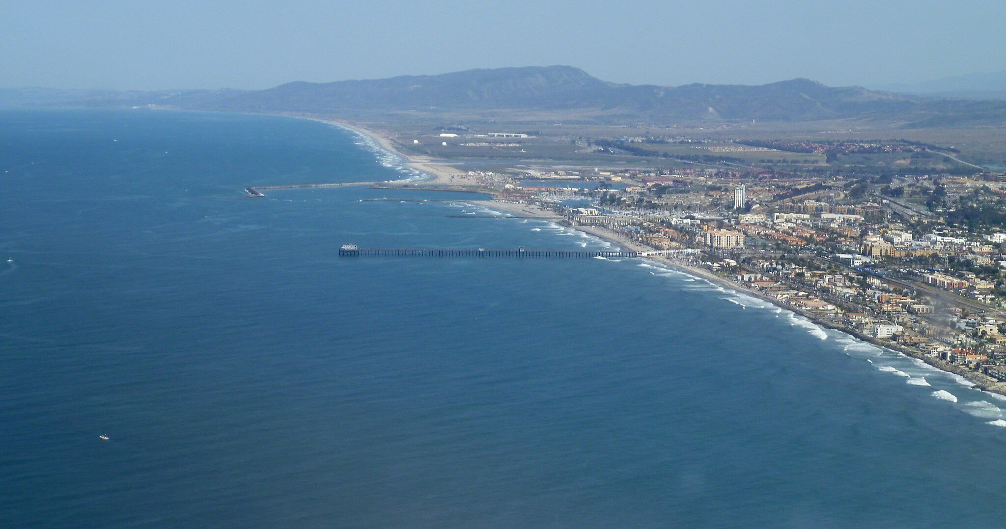 Ariel view of Oceanside Pier and  local real estate market.